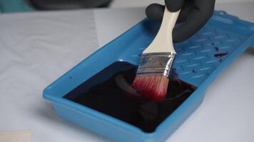 Preparing Paint Using a Brush in a Tray for Various Artistic Applications and Projects. Creative video