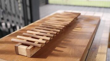 A beautifully crafted wooden musical instrument rests elegantly on a table, inviting play. Creative video