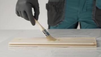 A craftsperson transforms wood with a beautiful stain, showcasing techniques. Creative video