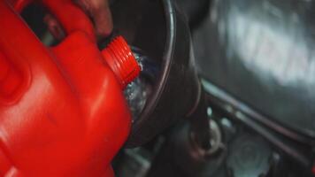 This is an essential refueling process that involves using a gasoline container for vehicles. Media video