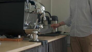 Talented Barista Preparing Delicious Coffee at an Espresso Machine in a Cozy Cafe Setting. Media video