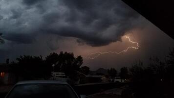 Lightning Strike Far Away on a Stormy Night, View from Driveway in Arizona photo