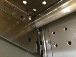 How to Hook a Metal Shelf into a Fixture Hole, Gray Pegboard in Retail photo