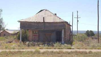 Old Abandoned Store, Boarded Up Building on the Side of the Road, New Mexico photo