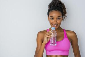 Smiling Woman Drinking Water After Workout photo