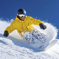 Snowboarder in Yellow Jacket Carving Through Fresh Powder photo