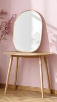 Light Wooden Vanity Table with Oval Mirror and Pink Wall photo