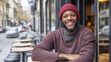 Smiling Man in Red Hat and Maroon Sweater at City Cafe photo
