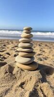 Balanced Stones Stack on Sandy Beach Ocean Background photo