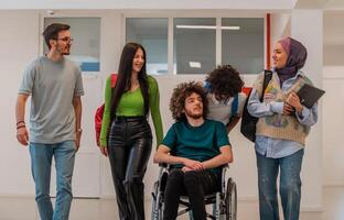 A group of happy diverse college students talking to each other while they walk in the university hallway. photo