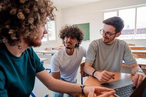 A group of happy diverse college students studying together in the classroom. photo