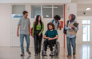 A group of happy diverse college students talking to each other while they walk in the university hallway. photo