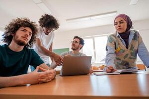 A group of diverse college students studying together or a business team working together on a project plan in the office workplace. photo