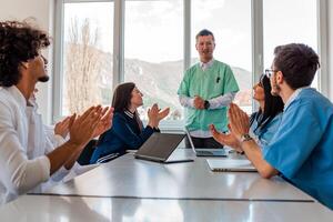 A medical team of doctors support and applause in celebration at the meeting in the office concept of teamwork leadership in business.. photo