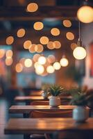 A restaurant with tables and chairs in front of a lighted ceiling photo
