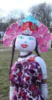 Funny burning doll with pigtails. Slavic Maslenitsa photo
