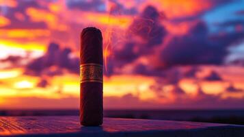 A cigar sitting on a table with a sunset in the background photo