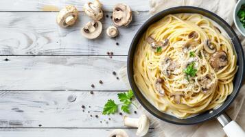 Spaghetti with mushrooms and herbs on a wooden table photo