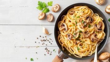 Spaghetti with mushrooms and herbs on a wooden table photo