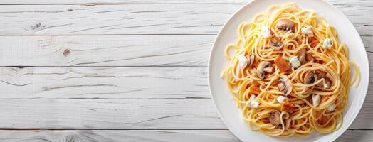 Spaghetti with mushrooms and cheese on a white plate photo