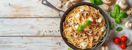 Spaghetti with mushrooms and tomatoes on a wooden table photo