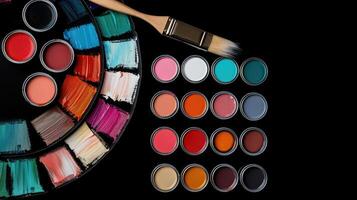 Paint palette with brush and paint on black background photo