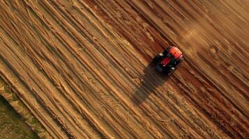 Aerial view of tractor plowing field photo