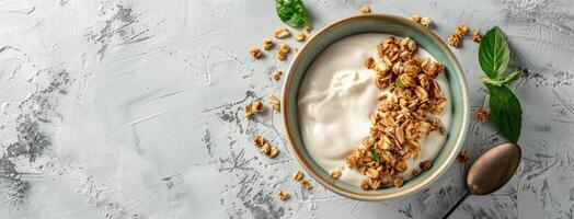 Yogurt with granola and mint leaves on a white background photo