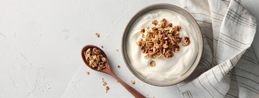Yogurt with granola and a spoon photo