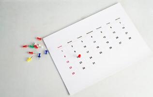red push pin on calendar for business background photo