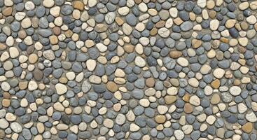 A stone wall with many different types of stones photo
