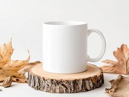 blank white mug on wooden slice surrounded by autumn leaves, perfect for cozy drinks photo