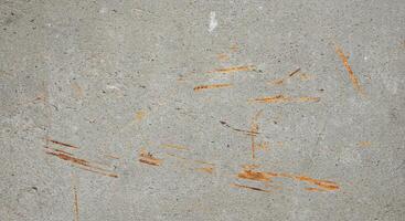 A concrete wall with orange paint on it photo