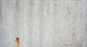 A red fire hydrant on a concrete wall photo
