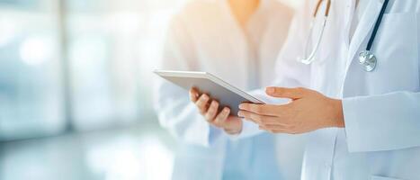 Healthcare professional using tablet for patient discussion in clinic photo