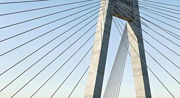 A bridge with many cables and a large structure photo