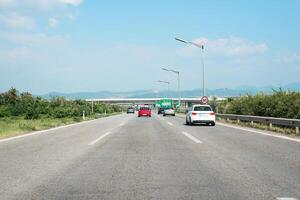 Driving along a highway with Mediterranean landscapes, capturing traffic flow and infrastructure, emphasizing transportation in Southern Europe photo