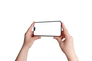 Hand holds a smartphone in a horizontal position with an unobstructed screen. Isolated display and background, ideal for landscape app mockup photo