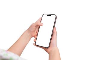 Young girl holds a smartphone in one hand while touching the screen with the other. Over the shoulder view, isolated display and background for mockup photo
