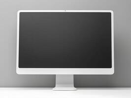A white computer monitor sitting on a desk photo