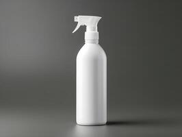 White spray bottle with a spray nozzle on a gray background photo