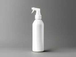 White spray bottle with a spray nozzle on a gray background photo