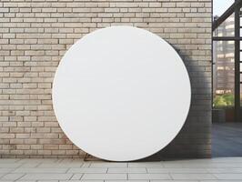 Round white mockup on brick wall in front of a window photo