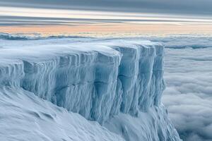 A large ice cliff with snow on top photo