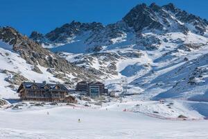 A ski resort with a lodge and a mountain in the background photo
