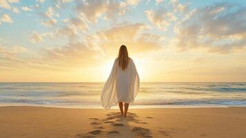 woman in flowing cape stands on beach at sunset, embracing tranquility photo