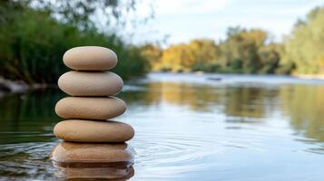 serene stack of smooth stones on calm river, surrounded by nature beauty photo
