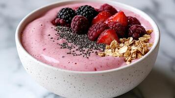 colorful smoothie bowl topped with berries and chia seeds photo