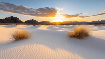 dramatic desert sunset with long shadows stretching across white sand dunes photo