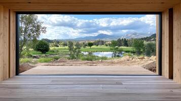 serene view of landscape through large window, showcasing greenery and mountains photo